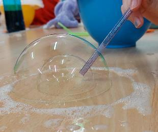 A pupil investigating bubbles and the behaviour of materials