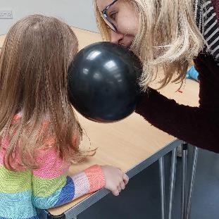 Children exploring sound with a balloon during a STEM Goes Wild session