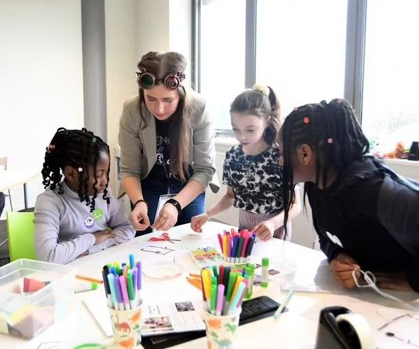 Kaja guiding children through a practical STEM activity
